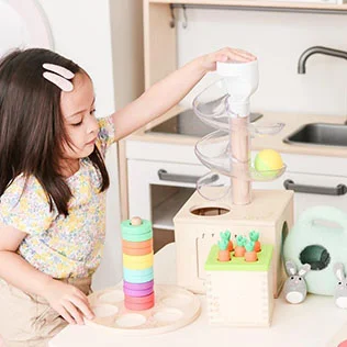 Child with playthings from The Babbler Play Kit